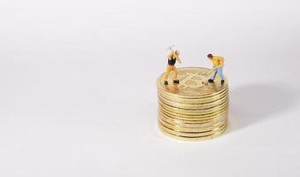 Worker figure standing on bitcoin. Bitcoin mining concept. photo