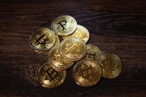 Bitcoin crypto currency isolated on wooden background. photo