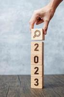 2023 block with magnifying glass icon. SEO, Search Engine Optimization, hiring , Advertising, Idea, Strategy, marketing, Keyword, Content and New Year start concepts photo