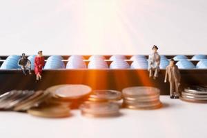 miniature people. Abacus and coin. Finance and business ideas. photo