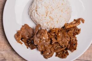 Fried pork with garlic and pepper in a white plate photo