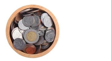 coin in a wooden cup on a white background photo