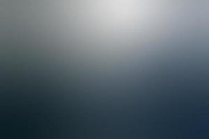 Abstract background in gradient colors of dark blue-grey and white.