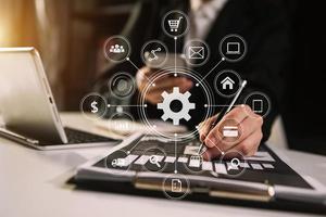 business documents on office table with smart phone and digital tablet and graph financial and man working photo