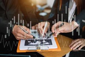 Business documents on office table with smart phone and calculator digital tablet and graph photo