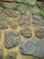 detalles de textura en las paredes de material de piedra, buenos para el fondo natural foto