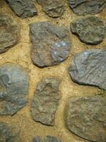 detalles de textura en las paredes de material de piedra, buenos para el fondo natural foto