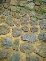 detalles de textura en las paredes de material de piedra, buenos para el fondo natural foto