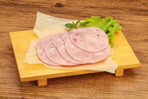 Slised ham snack over board photo