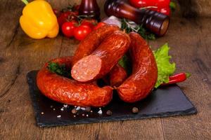 Pork sausages over wooden photo