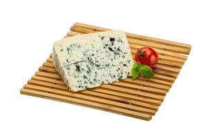 Blue cheese on board  isolated on white background photo