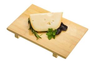 Maasdam cheese on board  isolated on white background photo