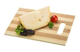 Maasdam cheese on board  isolated on white background photo