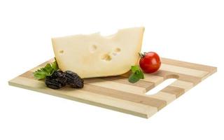 Maasdam cheese on board  isolated on white background photo