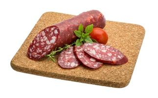 Salami sausages on wooden plate photo