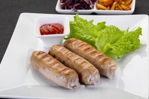 Grilled sausages served mushrooms and cabbage photo