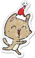 happy distressed sticker cartoon of a cat meowing wearing santa hat vector