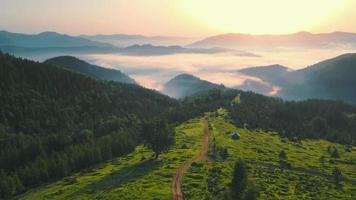 Dawn in the mountains from a bird's eye view. Smotrich Valley. The SUV is moving down a dirt road in the mountains. Hiking in the mountains. Sunrise in the mountains. Beautiful Ukrainian Carpathians video