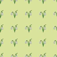 Seamless background of drawing snowdrops on a bright green background. Endless pattern with flower for your design. vector