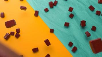 Chocolate chunks falling on colorful floor 3d illustration 3d rendering photo