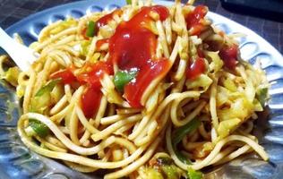 Schezwan Noodles or vegetable Hakka Noodles or chow mein is a popular Indo-Chinese recipes, served in a bowl or plate photo
