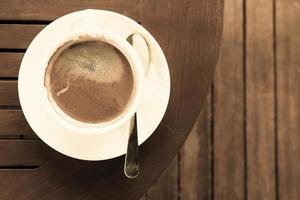 Coffee cup on wooden table photo