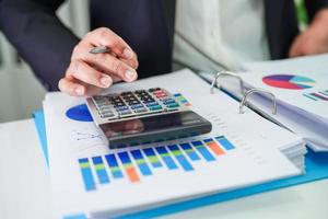 Businessman working and analysis with statistic graph in office. photo
