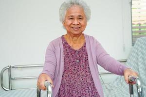 Asian elder senior woman patient sitting and smile face with happy on bed in hospital. photo