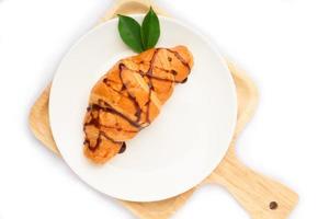 Fresh croissant in plate on white background photo
