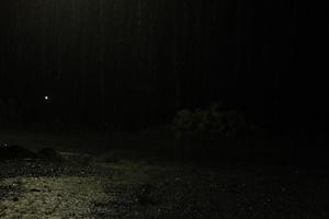 rain at night. Dark background shot of rain falling photo