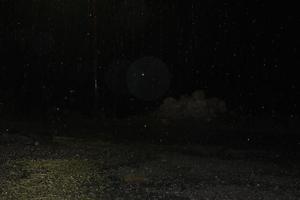 rain at night. Dark background shot of rain falling photo