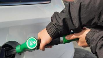 Person refueling gasoline in his vehicle before leaving for a trip photo