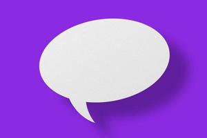 White paper in the shape of speech bubbles against a purple background. communication bubbles photo