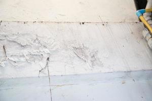 Water damaged ceiling roof in an old house. Water damage building interior. Ceiling house broken. Ceiling concrete crack and exposed the rusty steel bar frame. photo