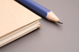 closed blank craft paper cover notebook with pencil. Office and study items close-up. photo