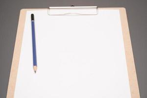 selective focus. a clipboard with a white sheet of paper photo