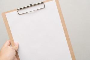 selective focus. a clipboard with a white sheet of paper photo