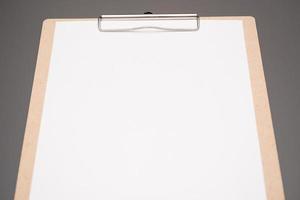 selective focus. a clipboard with a white sheet of paper photo