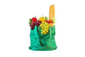 Fresh fruits and vegetables grocery product in green reusable shopping bag isolated on white background with clipping path photo