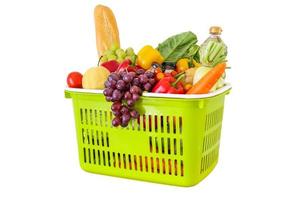 Fresh fruits and vegetables grocery product in green shopping basket isolated on white background photo