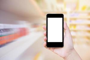 Pharmacy store with female holding mobile phone photo