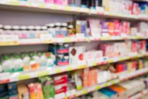 Pharmacy drug store interior blurred background with medicine on shelves photo