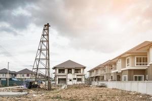 Residential new house building at construction site with clouds and blue sky photo