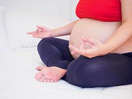 pregnant woman doing yoga photo