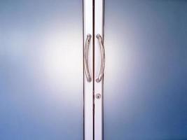 Glassdoors or front doors of the office which has stainless handlebars on their frame, soft and selective focus. photo