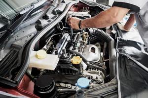 Mechanic working and repair car in car service centre photo