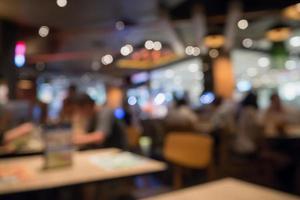 People in restaurant cafe interior with bokeh light blurred customer abstract background photo