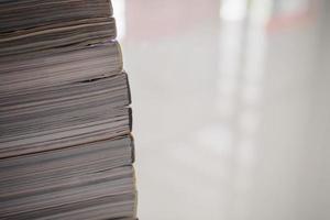 pile of magazines stack on white table in living room photo