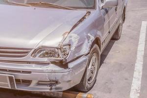 car damaged on the front cause by car crash accident on the road photo