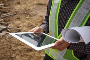 construction engineer worker using tablet computer at building site photo